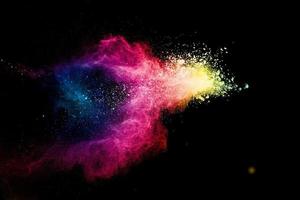 Abstract multicolored powder explosion on black background.
