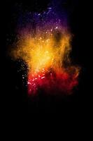 Multicolored powder explosion on black background photo