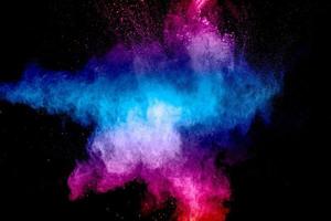 Pink blue dust particles splash on black background.Pink blue powder splash. photo