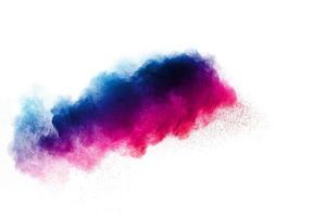 Launched colorful powder on black background.Color powder explosion.Colorful dust splashing. photo