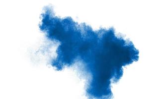 Blue color powder explosion cloud on white background.Closeup of Blue dust particles splash on background. photo