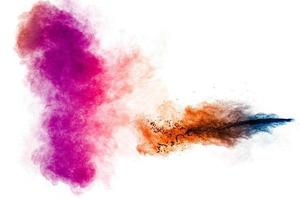 Multicolored particle exploding on white background. Colorful dust splashing. photo