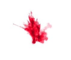 Abstract red dust splattered on white background. Red powder explosion.Freeze motion of red particles splash. photo