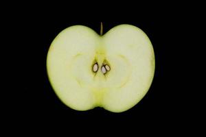 Fresh green apple and sliced isolated on black background. photo