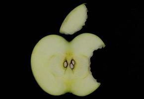 Fresh green apple and sliced isolated on black background. photo