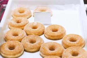 Donuts with price tag for sale in showcase photo