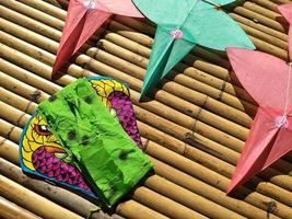 star-shaped kites and snake kite on wooden litter with light and shadow in Thai art of craft concept photo