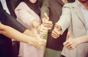 Success Teamwork Concepts, Business people with showing thumbs up hands as a team, Group of diverse hands together show thumb up, Young business team in the conference room photo