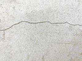 Crack concrete wall texture background. closeup white crack wall background in the building photo
