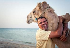 Camel owner on the coast of Tunisia with his camel, close-up photo