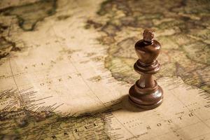 chess figure on map background concept for ideas photo