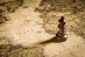 chess figure on map background concept for ideas photo