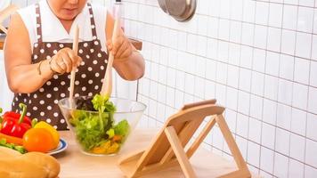 old woman cooking in the kitchen photo