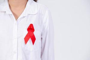 Girl's hands holding red breast cancer awareness ribbon and AIDS awareness ribbon photo