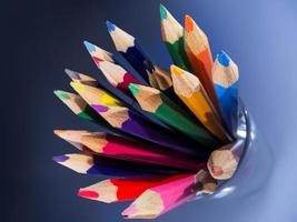 A group of coloured pencils in a glass tumbler photo