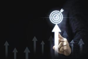 Hand touching up arrow with virtual target board for enhance and set up business objective target  goal concept. photo