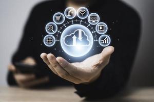 Businessman holding and giving virtual cloud computing with copy space to transfer data information and upload download application. Technology transformation concept. photo