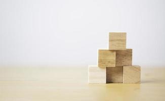 Stacking blank wooden cubes on table with copy space for input wording and infographic icon. photo