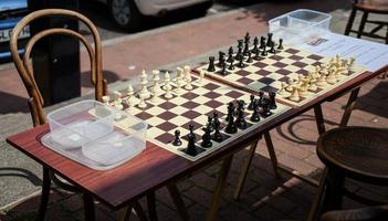 EAST GRINSTEAD, WEST SUSSEX, UK, 2017. Chess Boards in the Street Ready for a Game photo