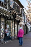 EAST GRINSTEAD,  WEST SUSSEX, UK, 2021. Woman looking in the bookshop window photo