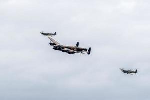 SHOREHAM-BY-SEA, WEST SUSSEX, UK, 2014. Avro Lancaster Flanked by Two Spitfires photo