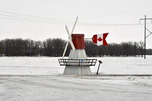 a windmill weather vane in the winter photo