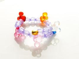 Multi-colored bracelets with beads. Colourful child's bead bracelet. photo