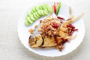 Deep Fried White Pomfret With Black Pepper Garlic, quick and easy dish. photo