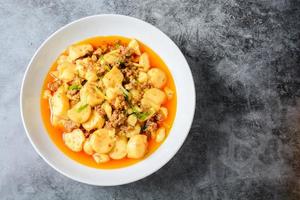 Mapo Tofu, popular Chinese dish.  The classic recipe consists of silken tofu, ground pork or beef and Sichuan peppercorn to name a few main ingredients.