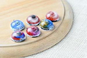 Create galaxy drink coasters using resin, glitter and pigment powders, handmade items. Suitable for keychains, necklace and pendant. photo