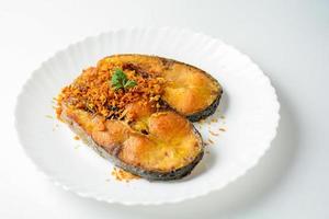 Deep Fried Pangasius fish with Black Pepper Garlic and fish source, quick and easy dish. photo
