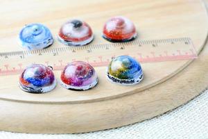 Create galaxy drink coasters using resin, glitter and pigment powders, handmade items. Suitable for keychains, necklace and pendant. photo