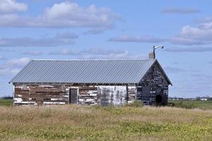 an old weathered farm building with a new roof photo