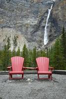 two red chairs by a waterfall photo