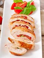 Grilled chicken breast stuffed with basil, tomato and garlic photo