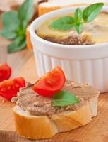 Homemade chicken liver pate, basil and slices of white bread photo