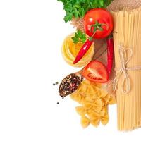 Pasta spaghetti, vegetables, spices isolated on white photo