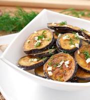 Platter of grilled eggplant with garlic and dill photo