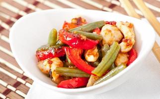 Chicken breast with vegetables and sauce decorated with basil leaves photo