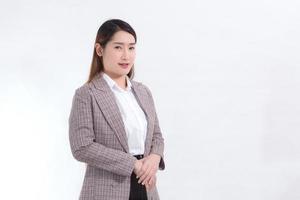 Portrait Asian woman who wears formal suit with white shirt stands alone on white background. photo