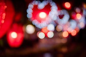 City night light blur bokeh , defocused red heart light background. photo