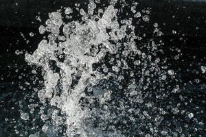 Water Splash on black background.Stylish water splash. Isolated on black background. photo