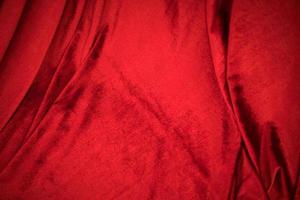 Fold soft waved red velour fabric textured background. photo