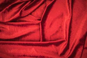 Fold soft waved red velour fabric textured background. photo