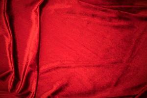 Fold soft waved red velour fabric textured background. photo