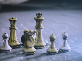 Golden king chess to fighting silver king chess to play successfully in the competition with technology network background. Management or leadership strategy concept. photo