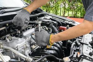 Hands of car mechanic in auto repair service. photo