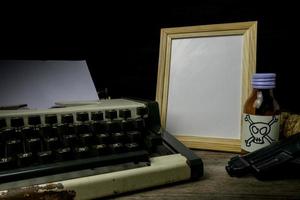 Typewriter with paper page and poison and gun. Concept writer Romance Suspense photo