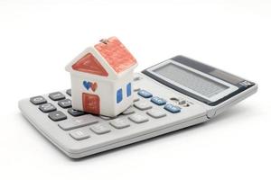 House and calculator on white background photo