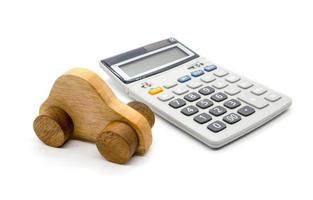 Calculator and car wood on white background photo